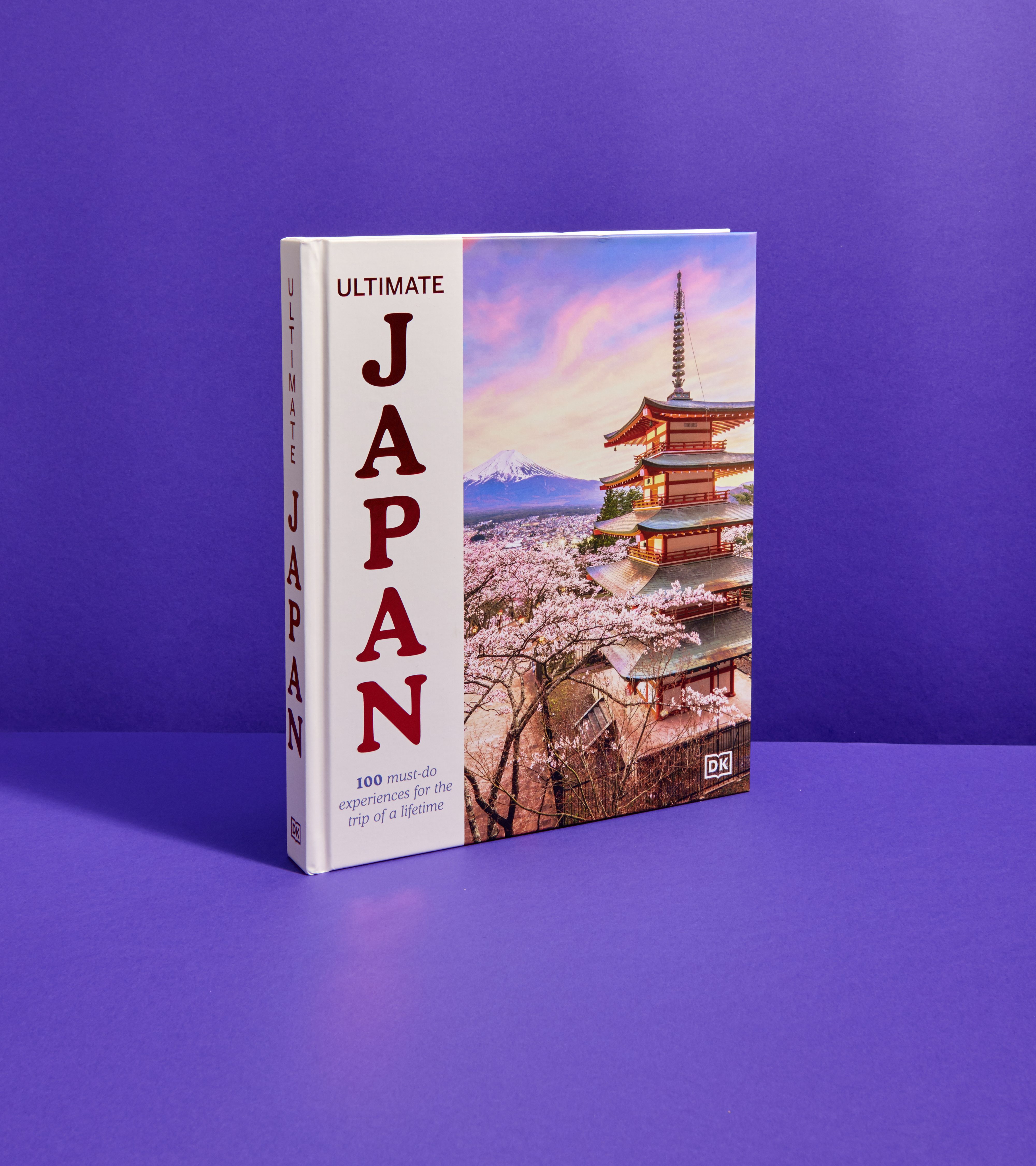 Cover of DK Ultimate Japan, at an angle against a deep purple background